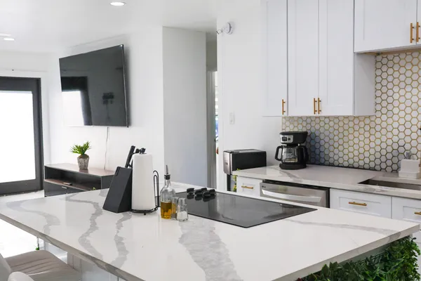 a kitchen with a stove a sink and a counter top space