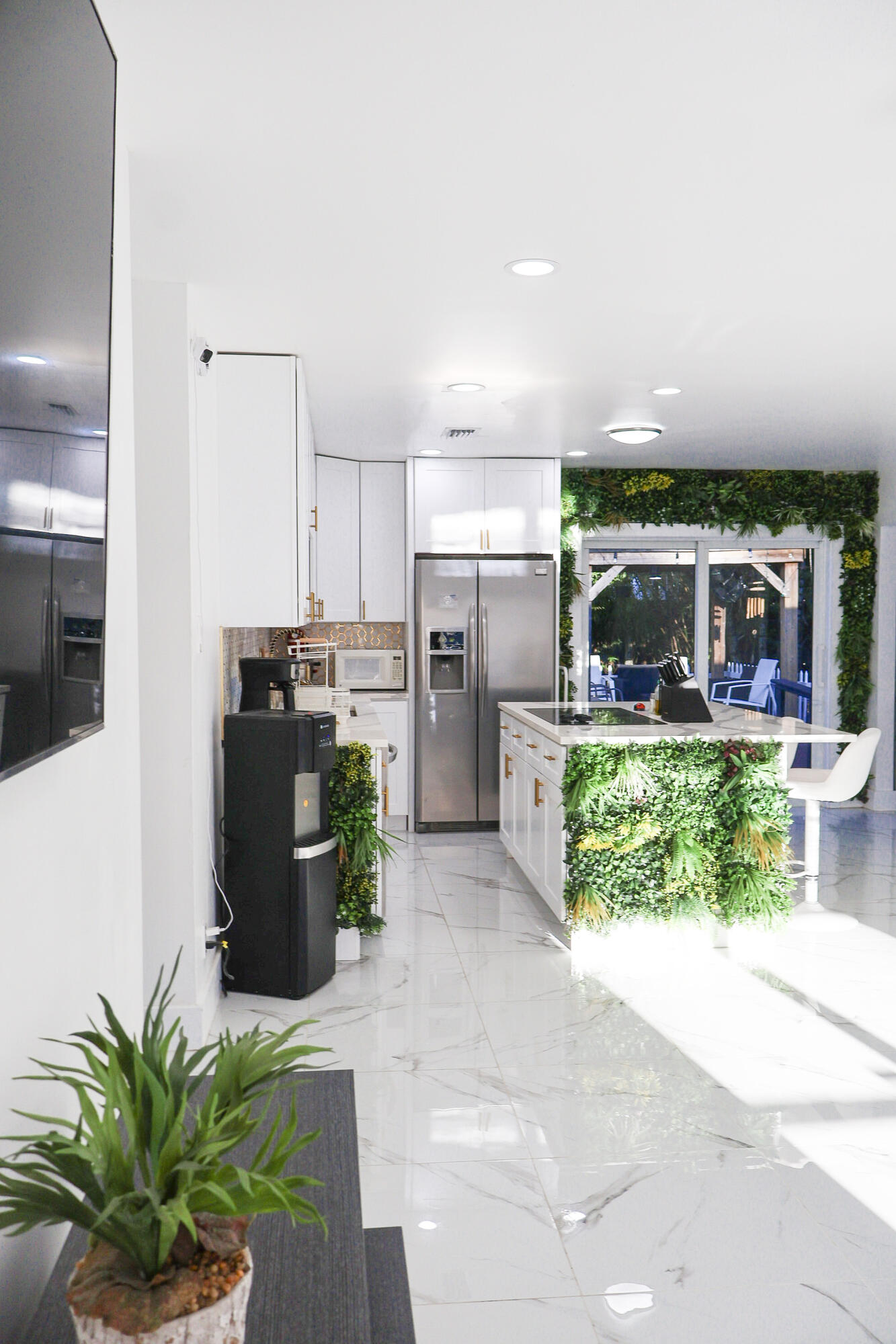 5905 Triphammer Road Lake Worth, FL 33463 - Photo 8 of 16 a kitchen with stainless steel appliances a refrigerator a stove a sink a dining table and chairs