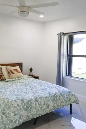 a bedroom with a bed and window