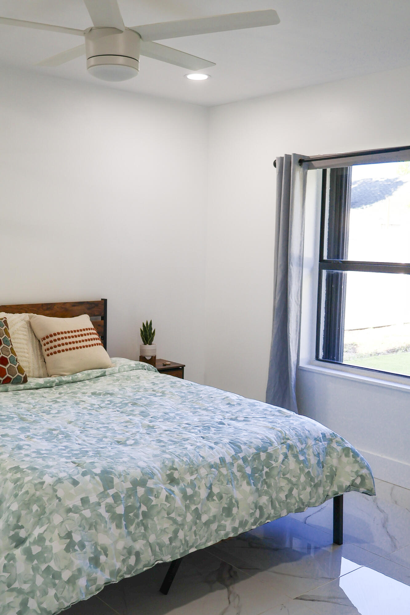 5905 Triphammer Road Lake Worth, FL 33463 - Photo 9 of 16 a bedroom with a bed and window