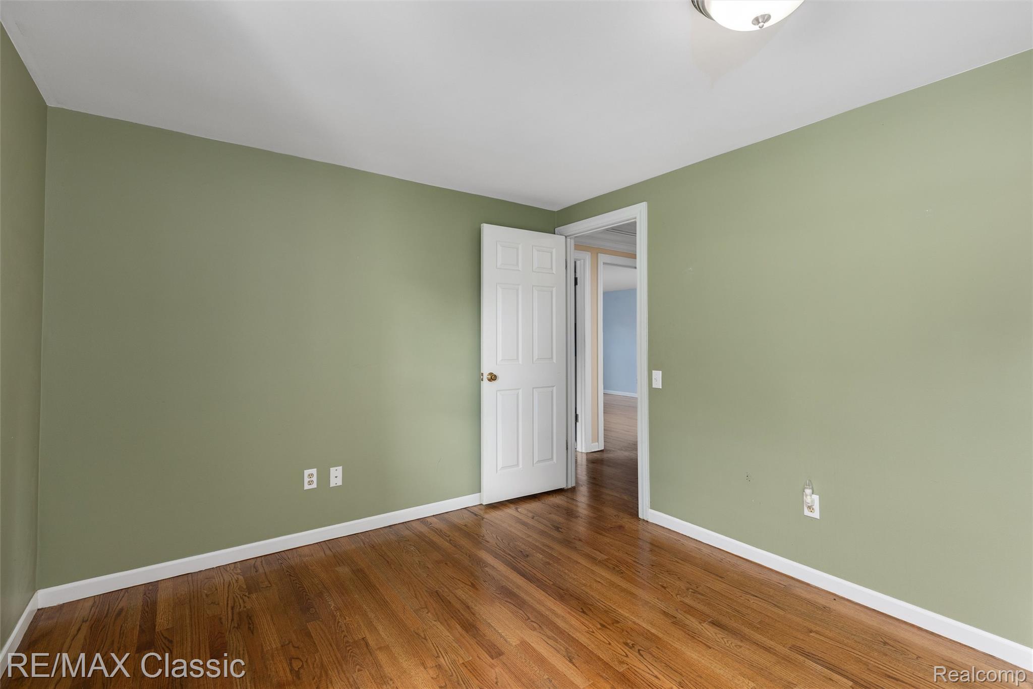 4268 Covered Bridge Road Bloomfield Hills, MI 48302 - Photo 21 of 35 Room with wood-finish flooring, light green walls, and white trim