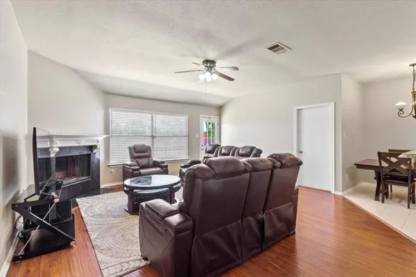 a living room with furniture fireplace and a table