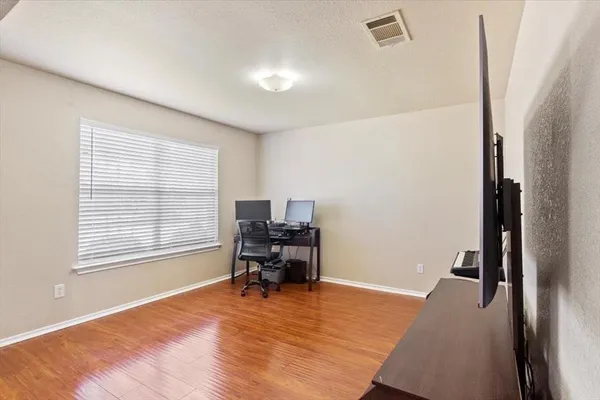 a view of a workspace with furniture and a window
