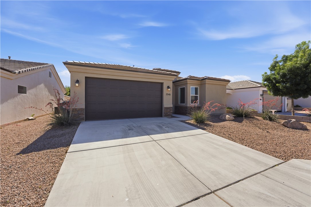 3546 North Skylark Road Kingman, AZ 86409 - Photo 19 of 30 a front view of a house with a yard and garage