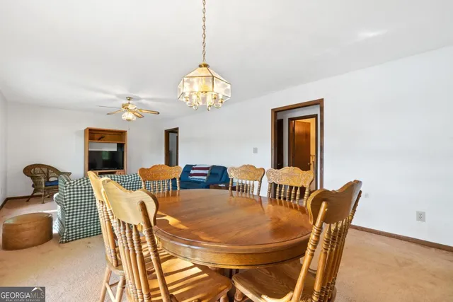 a view of a dining room with furniture and chandelier