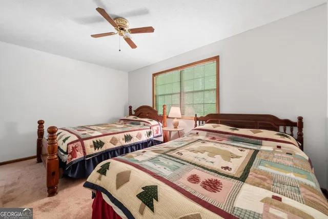 a bedroom with two beds and a large window