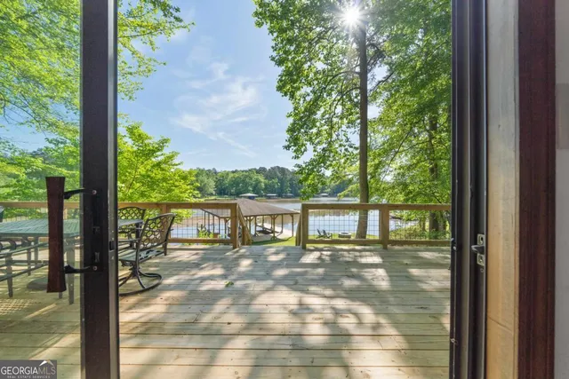 a view of a balcony with floor to ceiling windows and wooden floor