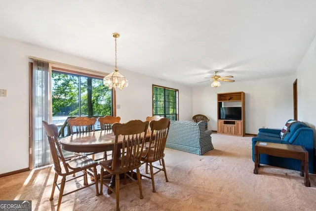 a dining room with furniture window and outside view