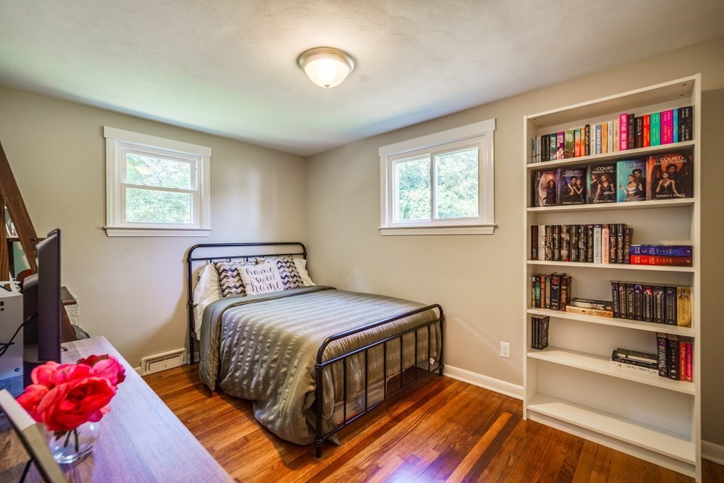 72 Wachusett Street Springfield, MA 01118 - Photo 18 of 28 a bedroom with a bed and a book shelf