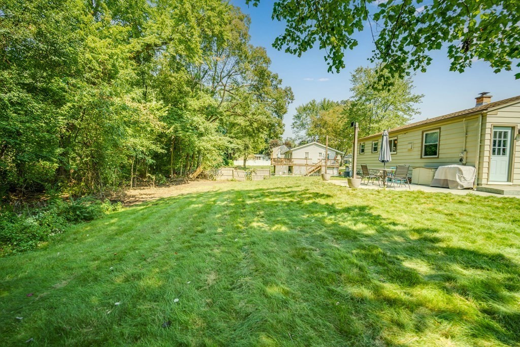 72 Wachusett Street Springfield, MA 01118 - Photo 26 of 28 a backyard of a house with table and chairs