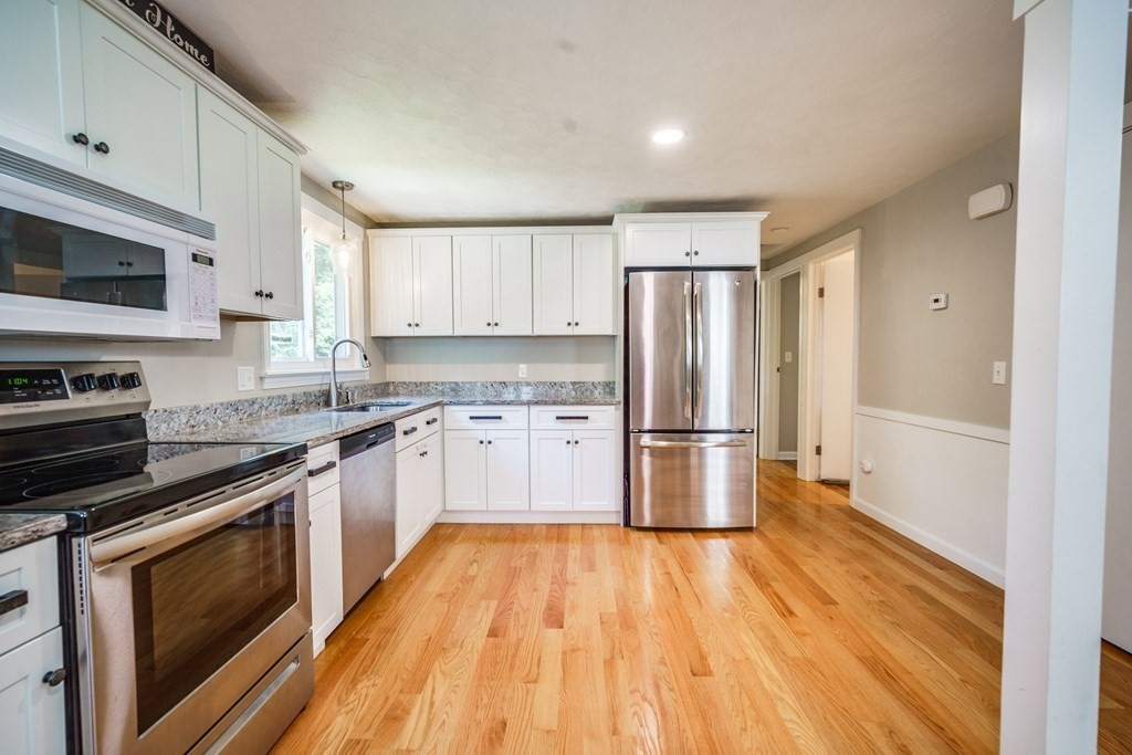 72 Wachusett Street Springfield, MA 01118 - Photo 9 of 28 a kitchen with stainless steel appliances a refrigerator sink and stove top oven
