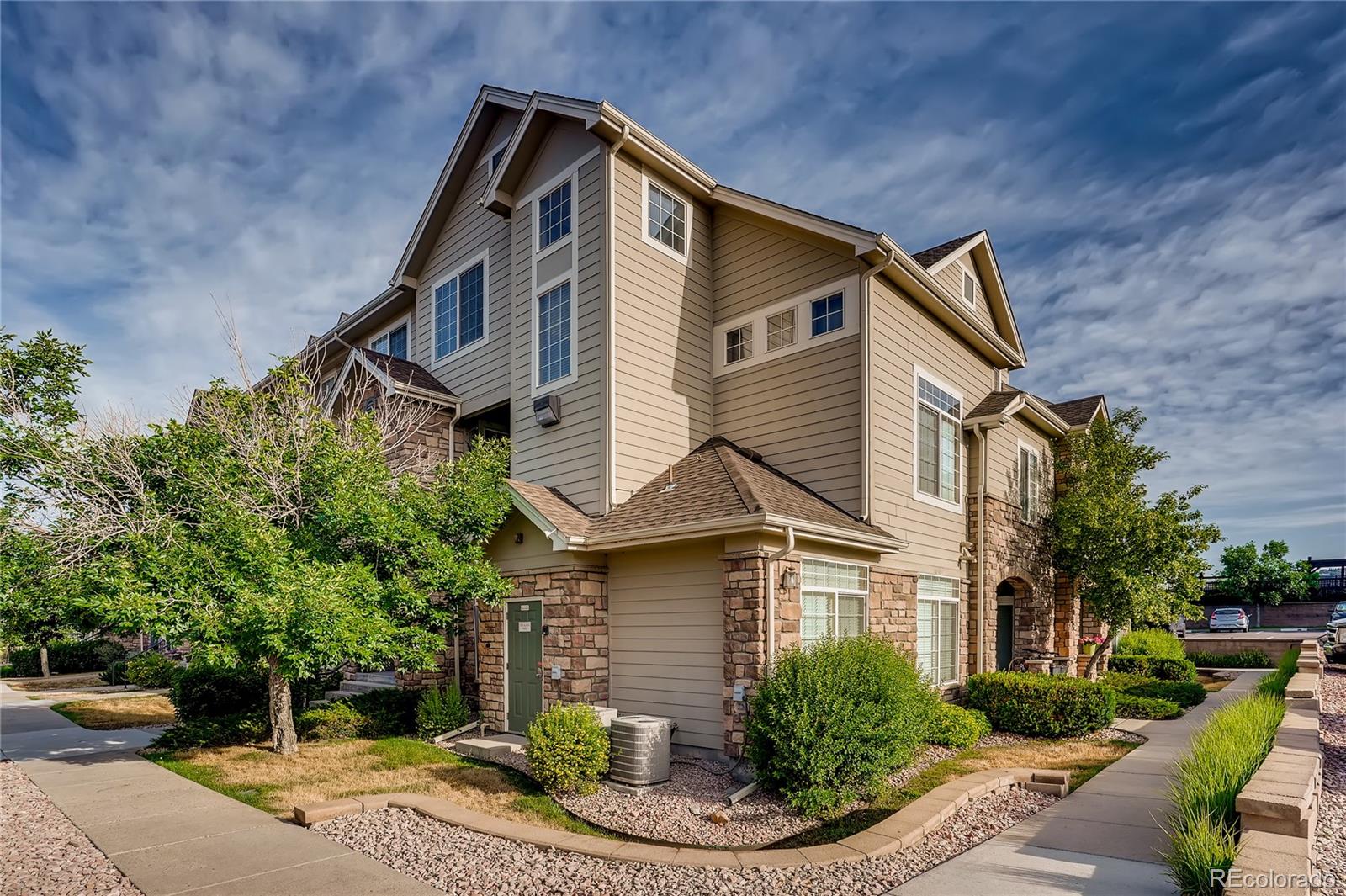 457 Black Feather Loop, Unit 709 Castle Rock, CO 80104 - Photo 1 of 11 a front view of a house with a yard
