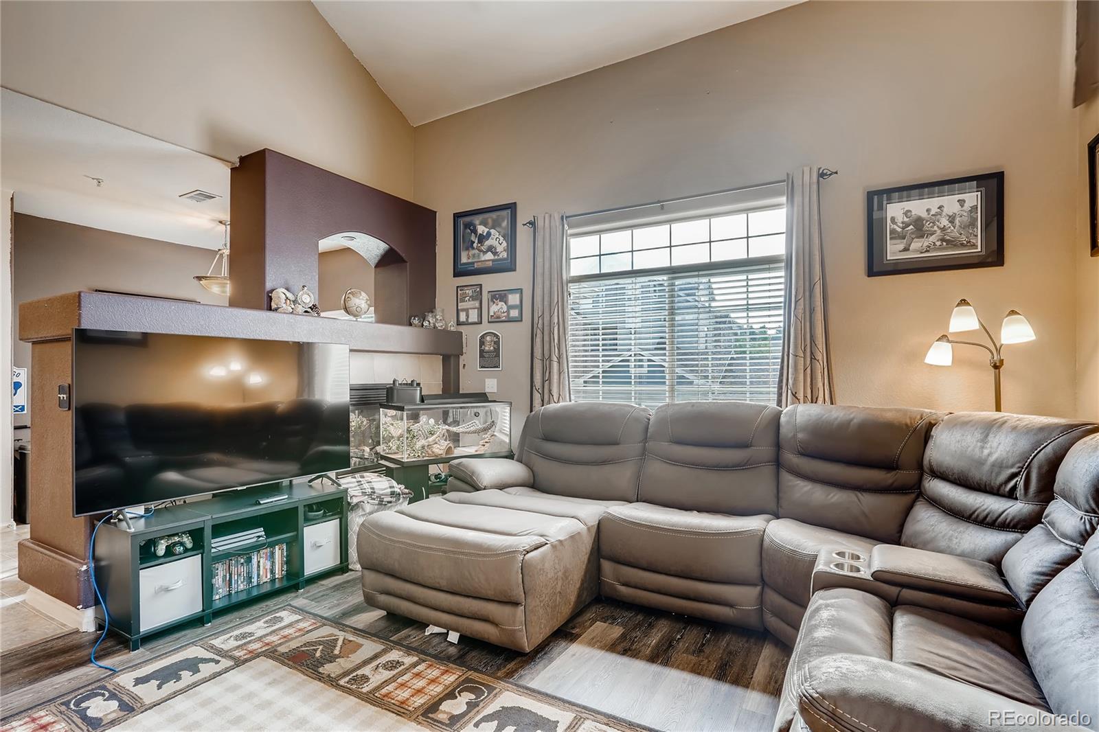 457 Black Feather Loop, Unit 709 Castle Rock, CO 80104 - Photo 2 of 11 a living room with furniture and a flat screen tv