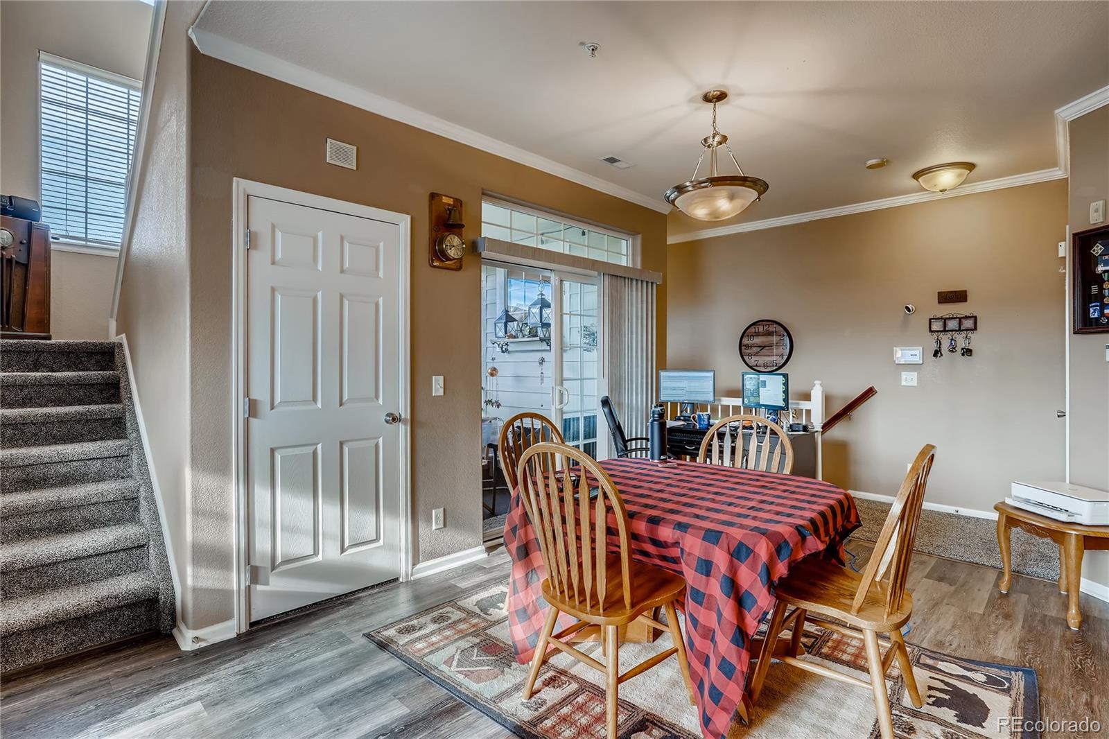 457 Black Feather Loop, Unit 709 Castle Rock, CO 80104 - Photo 3 of 11 a view of a dining room with furniture wooden floor and chandelier
