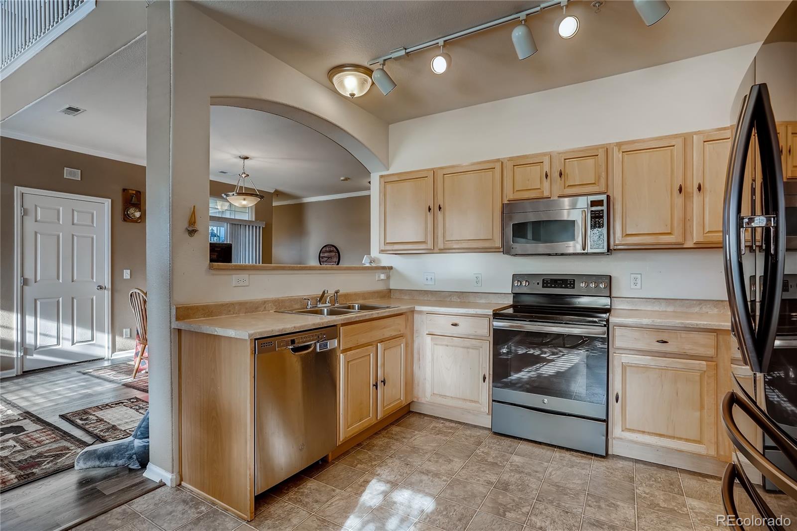 457 Black Feather Loop, Unit 709 Castle Rock, CO 80104 - Photo 5 of 11 a kitchen with stainless steel appliances a stove sink and refrigerator