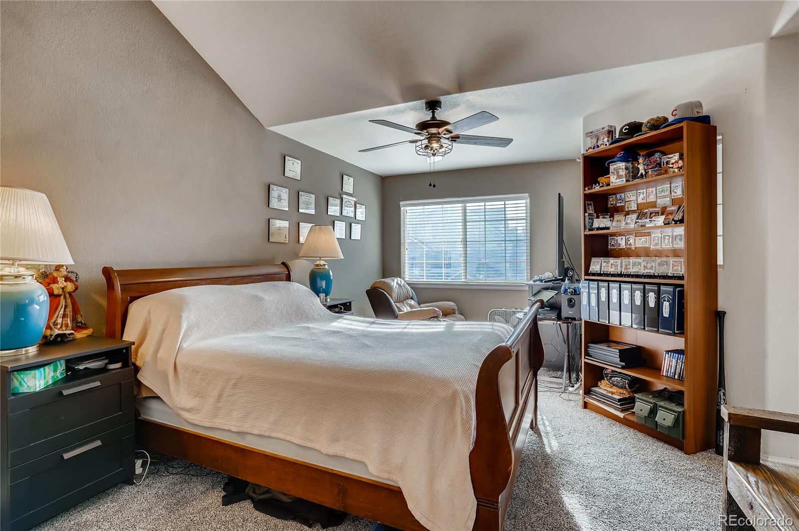 457 Black Feather Loop, Unit 709 Castle Rock, CO 80104 - Photo 6 of 11 a bed room with bed and a book shelf