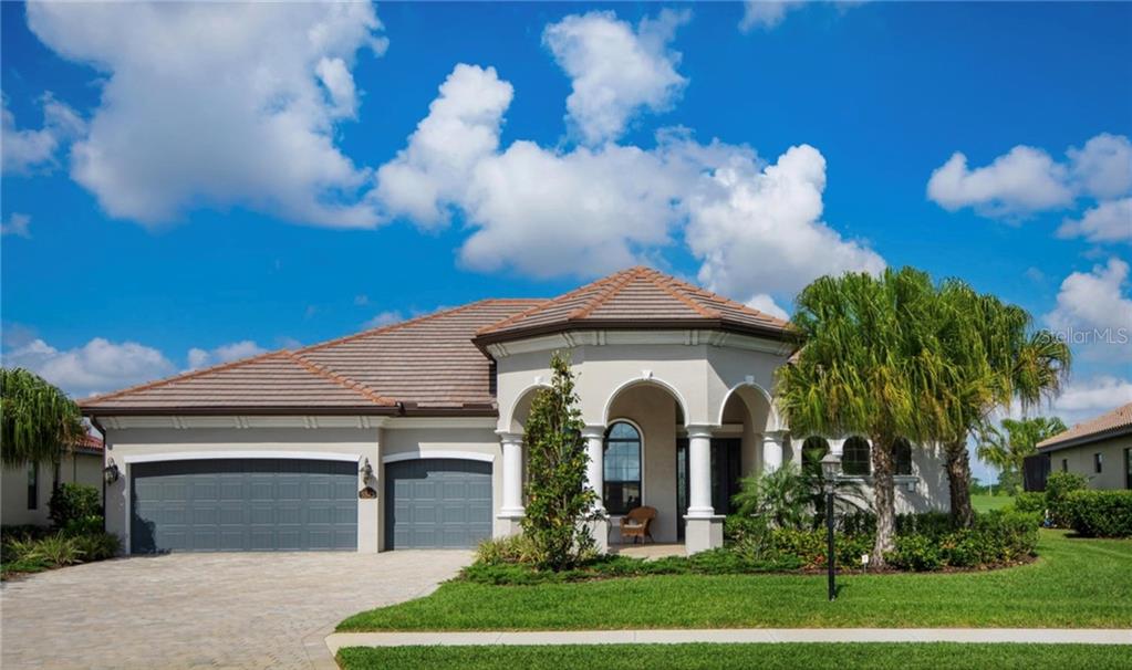 5543 Arnie Loop Bradenton, FL 34211 - Photo 1 of 45 a front view of a house with a garden