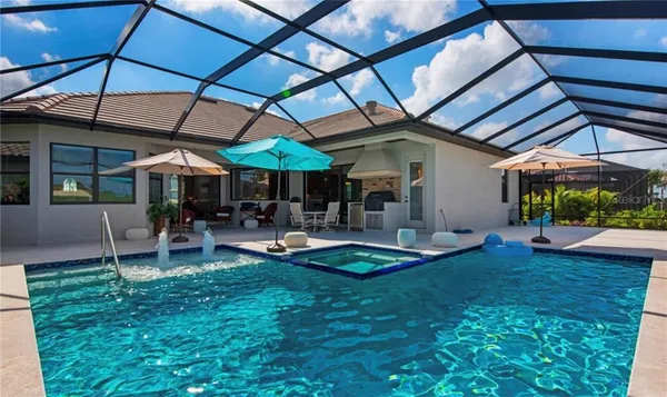 a view of a backyard with table and chairs under an umbrella