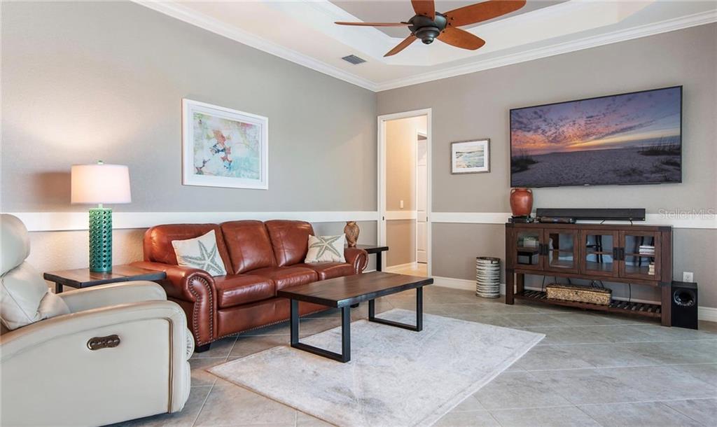5543 Arnie Loop Bradenton, FL 34211 - Photo 19 of 45 a living room with furniture and a flat screen tv