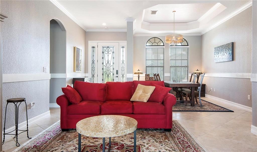 5543 Arnie Loop Bradenton, FL 34211 - Photo 21 of 45 a living room with furniture and a large window