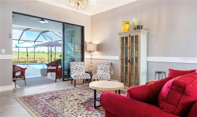 a living room with furniture a rug and a large window