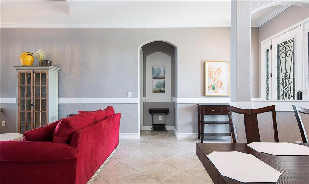 5543 Arnie Loop Bradenton, FL 34211 - Photo 27 of 45 a living room with furniture fireplace and a window