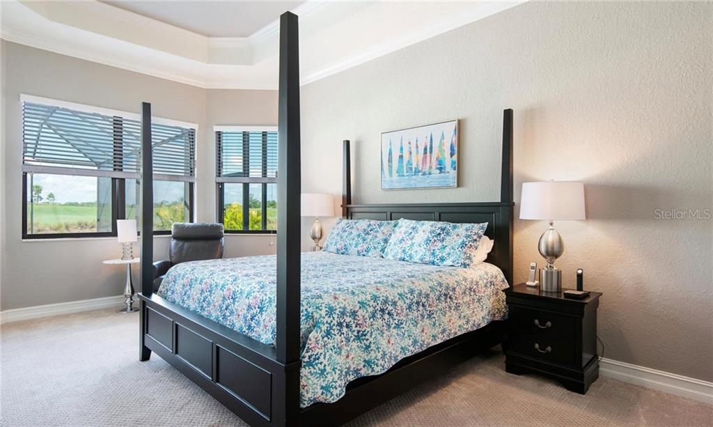 5543 Arnie Loop Bradenton, FL 34211 - Photo 29 of 45 a bedroom with a bed and large window