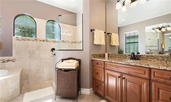 a kitchen with stainless steel appliances granite countertop a sink refrigerator stove and microwave