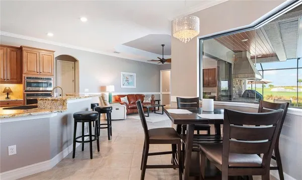 a kitchen with kitchen island granite countertop a sink stove and refrigerator
