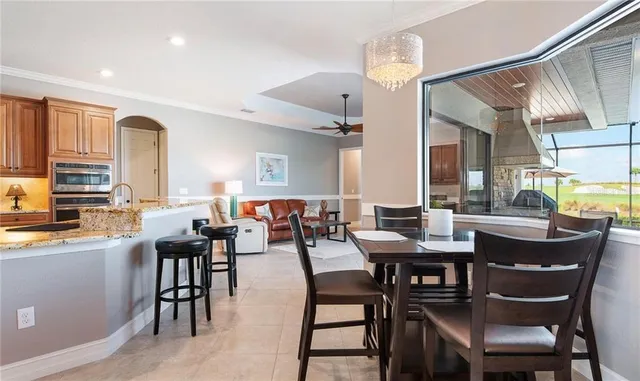 a kitchen with kitchen island granite countertop a sink stove and refrigerator