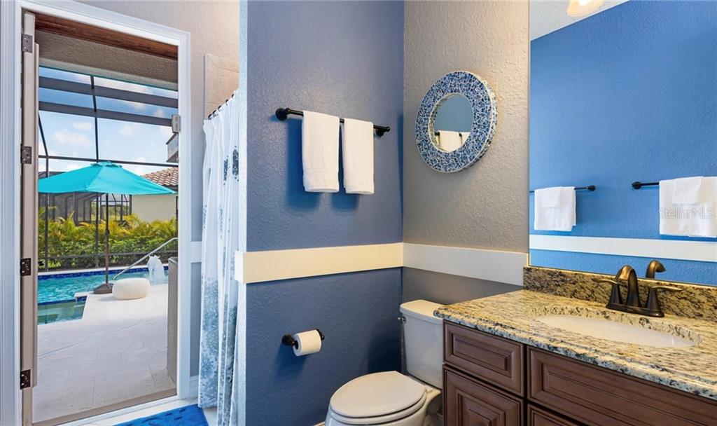 5543 Arnie Loop Bradenton, FL 34211 - Photo 42 of 45 a bathroom with a granite countertop sink and a mirror