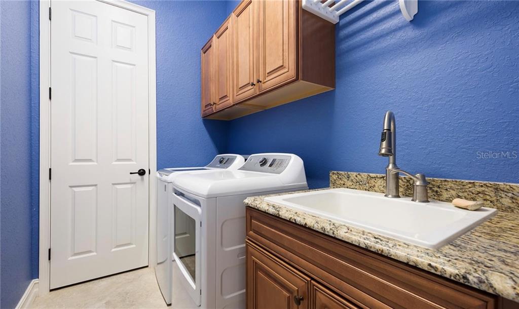 5543 Arnie Loop Bradenton, FL 34211 - Photo 43 of 45 a bathroom with a granite countertop sink and a mirror