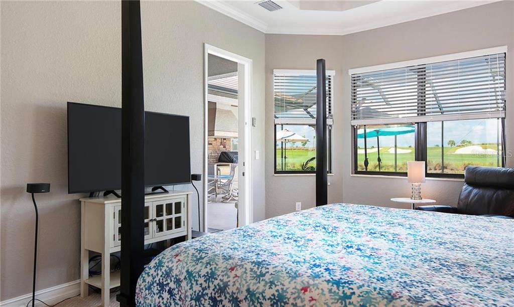 5543 Arnie Loop Bradenton, FL 34211 - Photo 5 of 45 a bedroom with a bed television and a large window