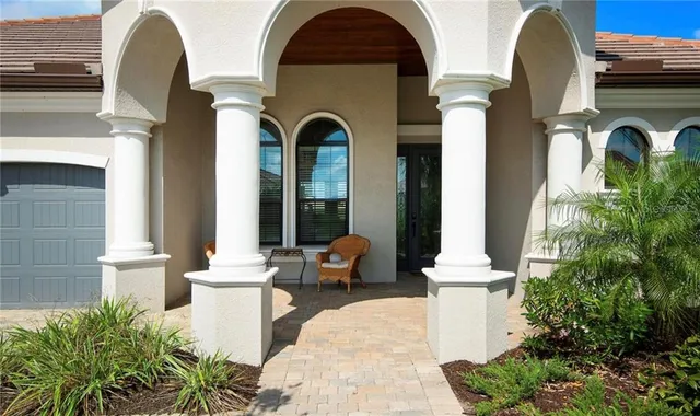 a front view of a house with outdoor seating and plants