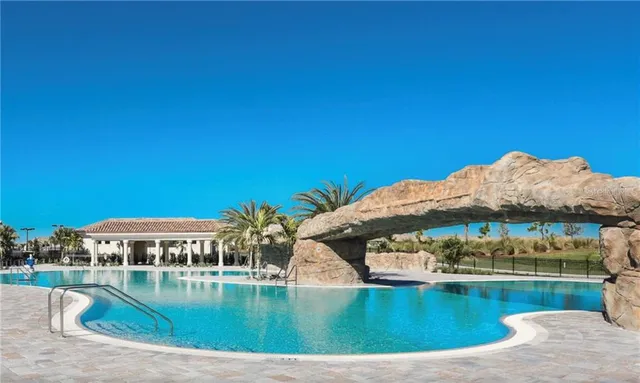 a view of swimming pool with outdoor seating and garden