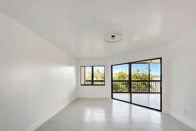 a bedroom with bed and large window