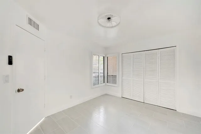 a bathroom with a toilet a sink a mirror a bathtub and vanity