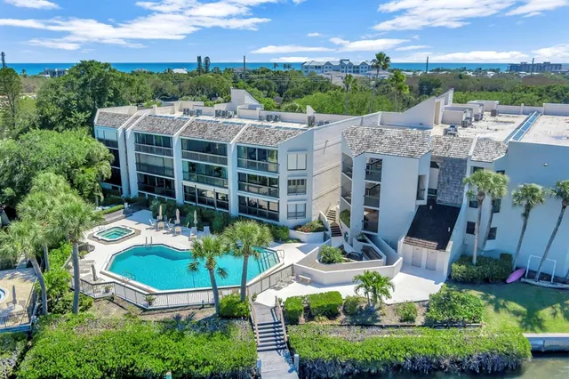 a view of a patio with table and chairs potted plants with wooden fence