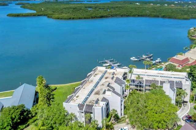a view of a house with a yard and a pond
