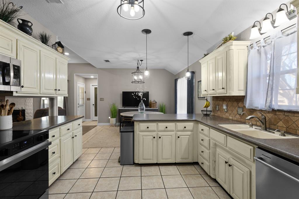 1701 Oakmeadow Drive Decatur, TX 76234 - Photo 6 of 39 a large kitchen with stainless steel appliances lots of counter space sink and cabinets