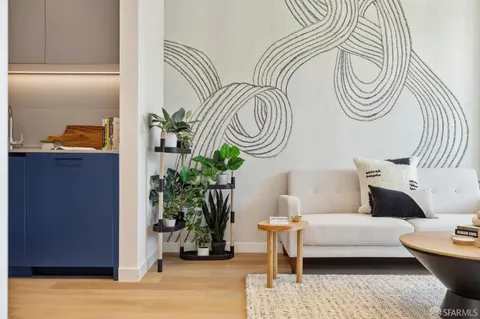 a living room with furniture and a potted plant