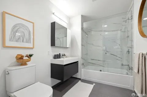 a bathroom with a toilet a sink and bathtub