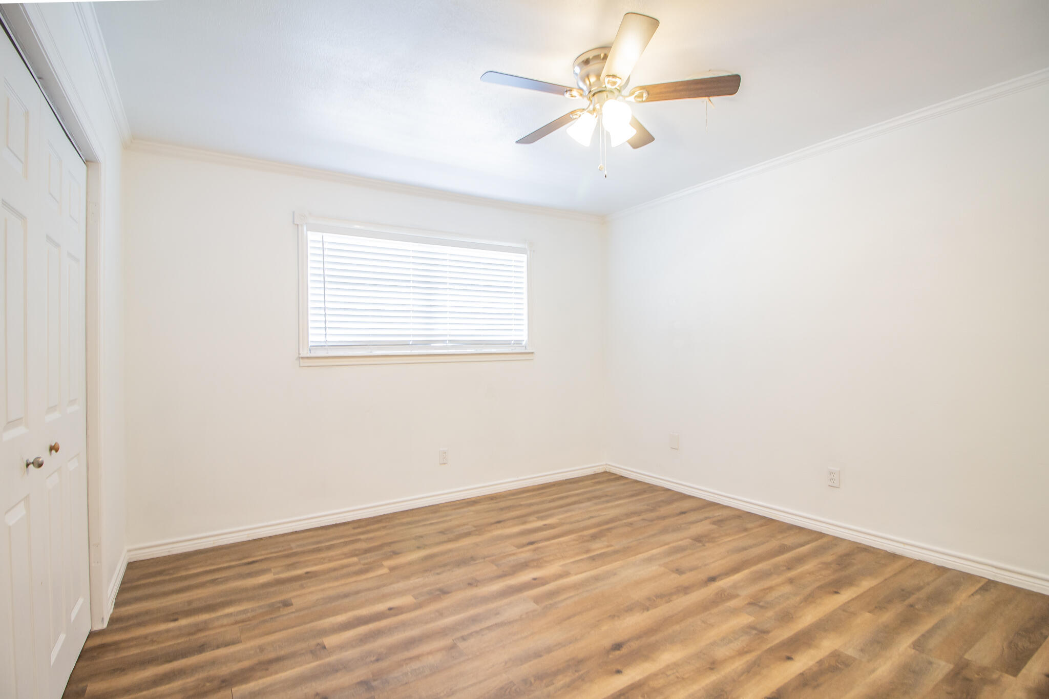 5503 9th Street Lubbock, TX 79416 - Photo 15 of 31 an empty room with a window and a fan
