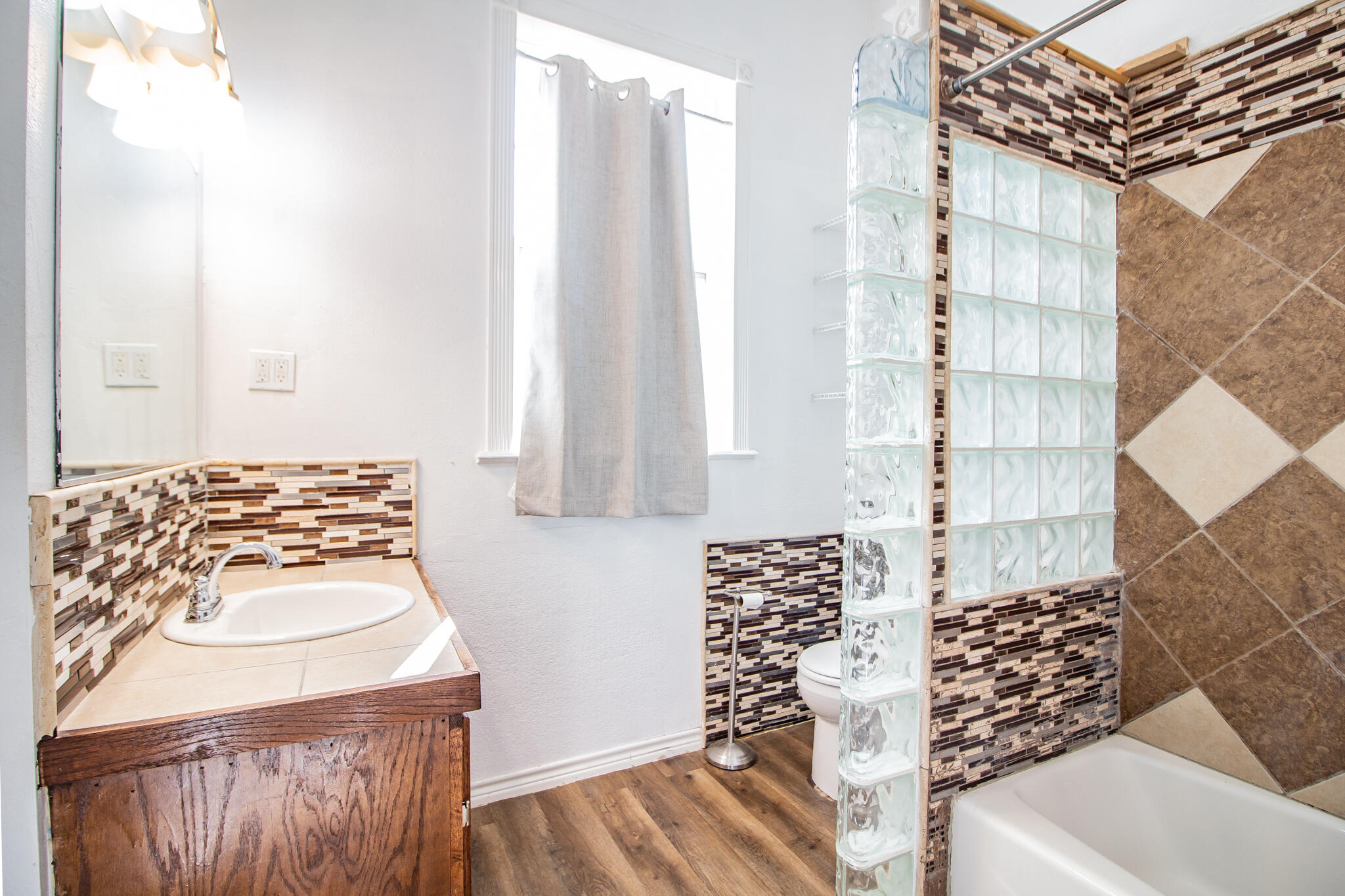 5503 9th Street Lubbock, TX 79416 - Photo 16 of 31 a bathroom with a bathtub and shower