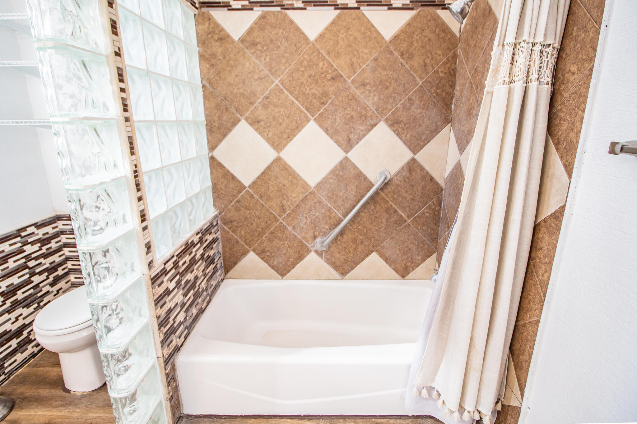 5503 9th Street Lubbock, TX 79416 - Photo 17 of 31 a white bath tub sitting next to a white door