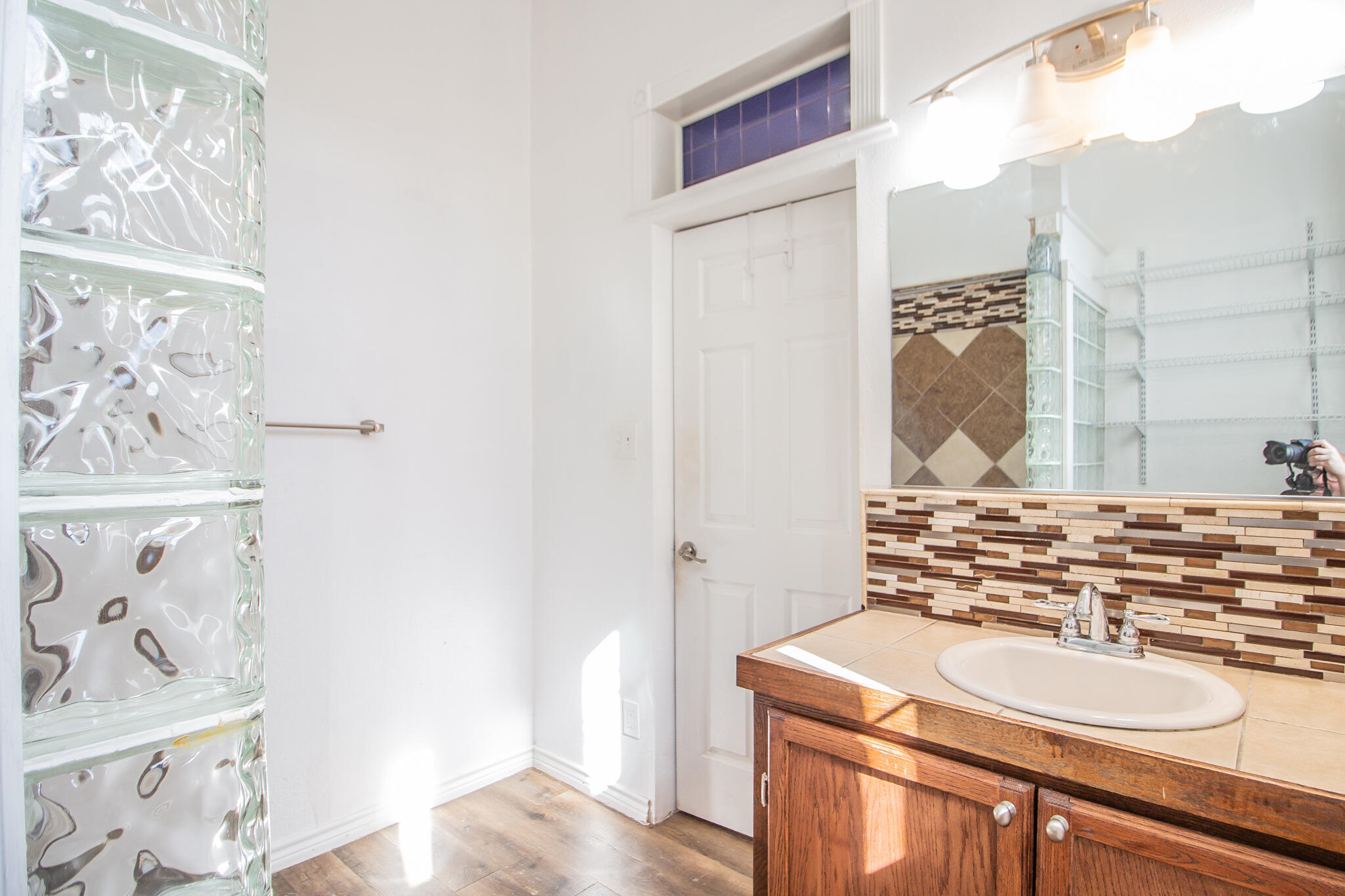 5503 9th Street Lubbock, TX 79416 - Photo 18 of 31 a bathroom with a sink mirror and vanity