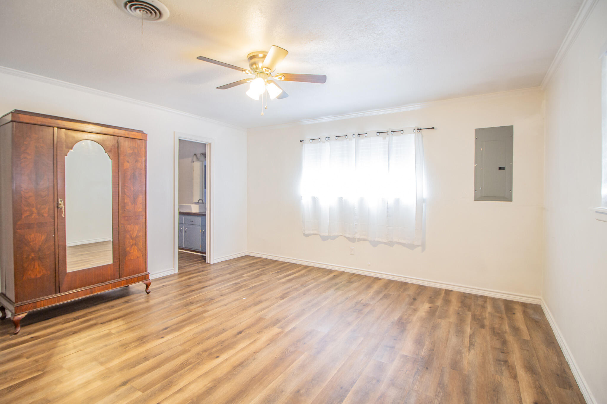 5503 9th Street Lubbock, TX 79416 - Photo 19 of 31 wooden floor in an empty room with a window