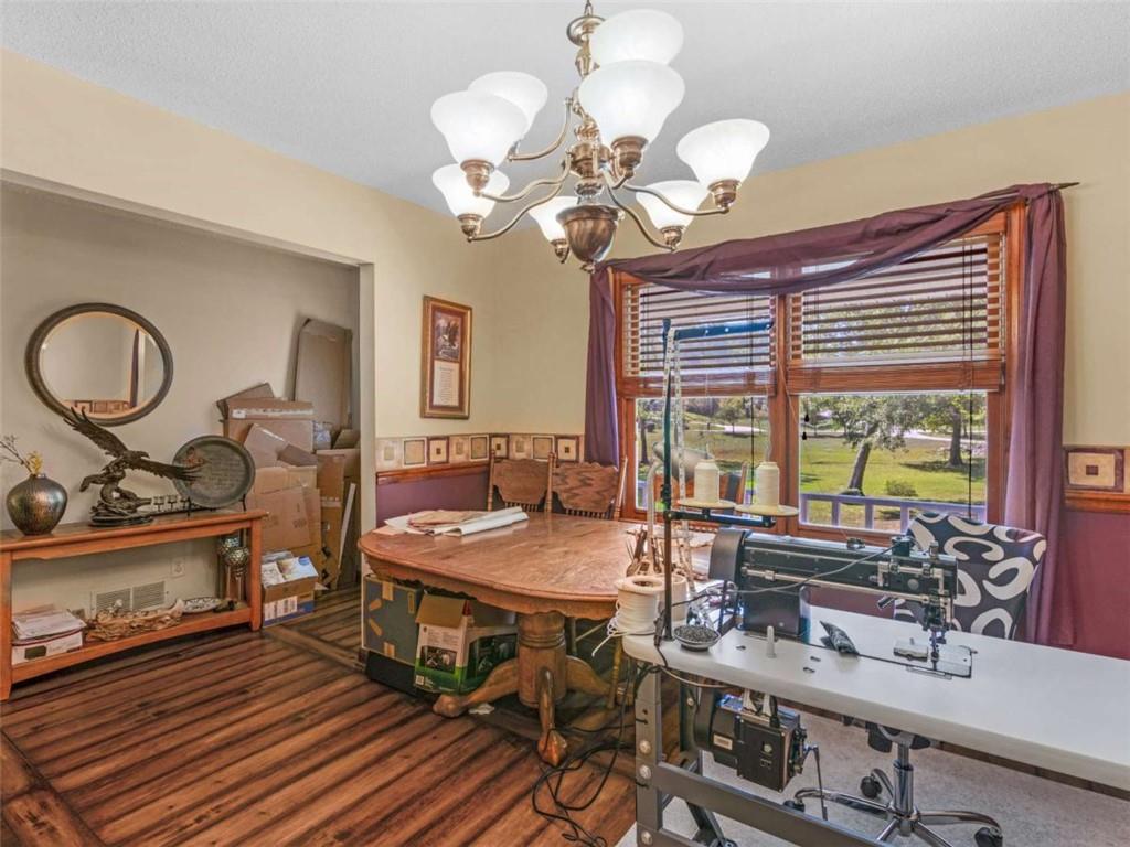 5 Ridgewood Circle McDonough, GA 30252 - Photo 11 of 20 a dining room filled chandelier and wooden floor