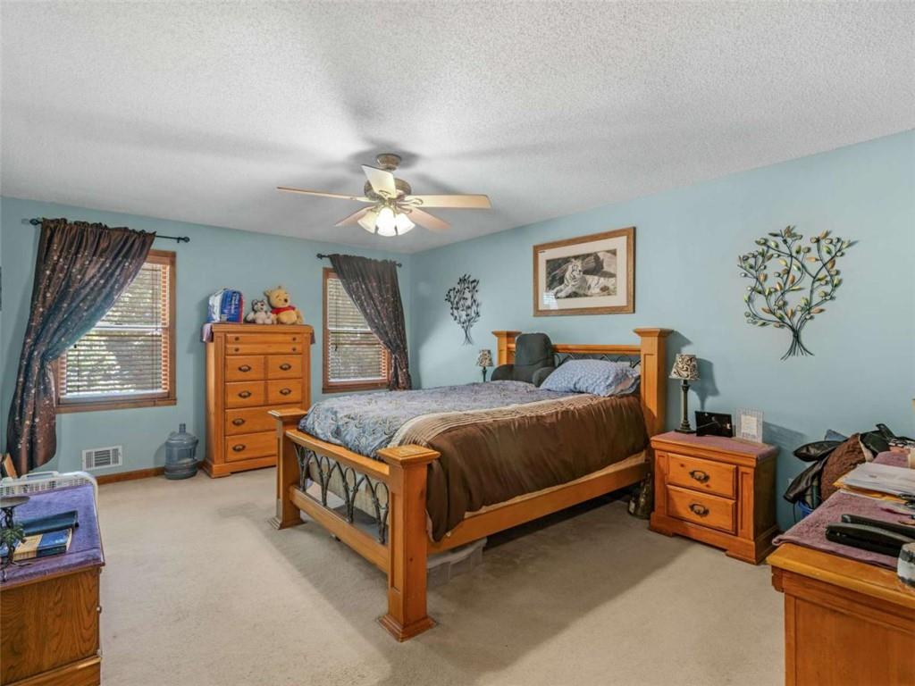 5 Ridgewood Circle McDonough, GA 30252 - Photo 12 of 20 a bedroom with a bed and a tv