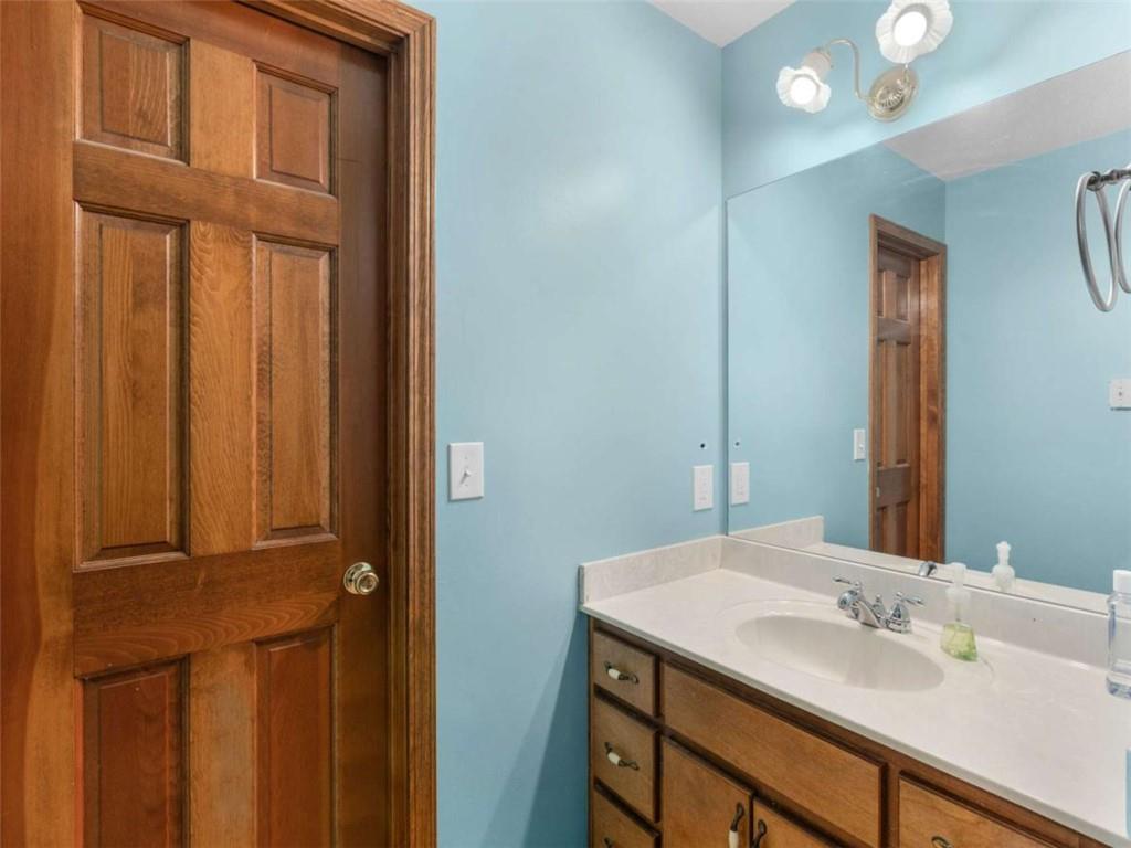 5 Ridgewood Circle McDonough, GA 30252 - Photo 14 of 20 a bathroom with a sink and a mirror